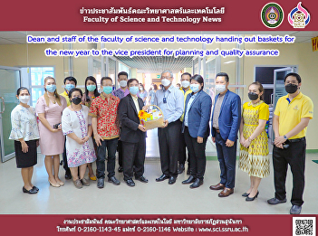 Dean and staff of the faculty of science
and technology handing out baskets for
the new year to the vice president for
planning and quality assurance