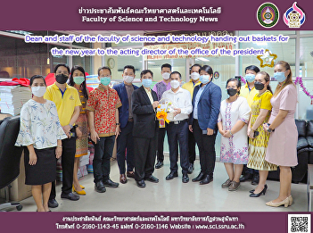 Dean and staff of the faculty of science
and technology handing out baskets for
the new year to the acting director of
the office of the president